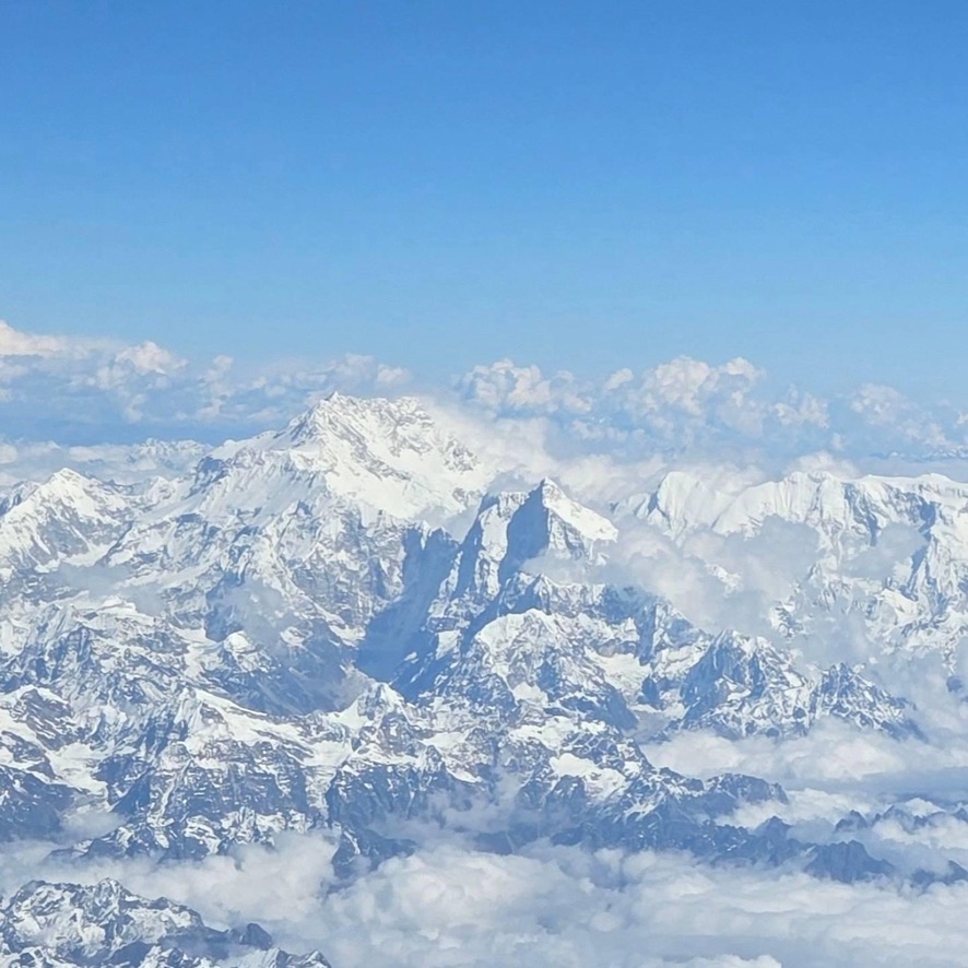 Snow-capped peaks of the Himalayas above the clouds, the breed's ancestral home