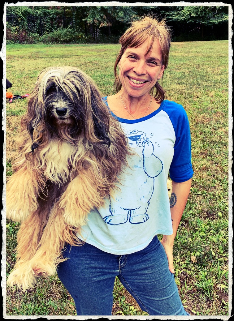 Deidre Philpot holding one of her Tibetan Terriers in the yard